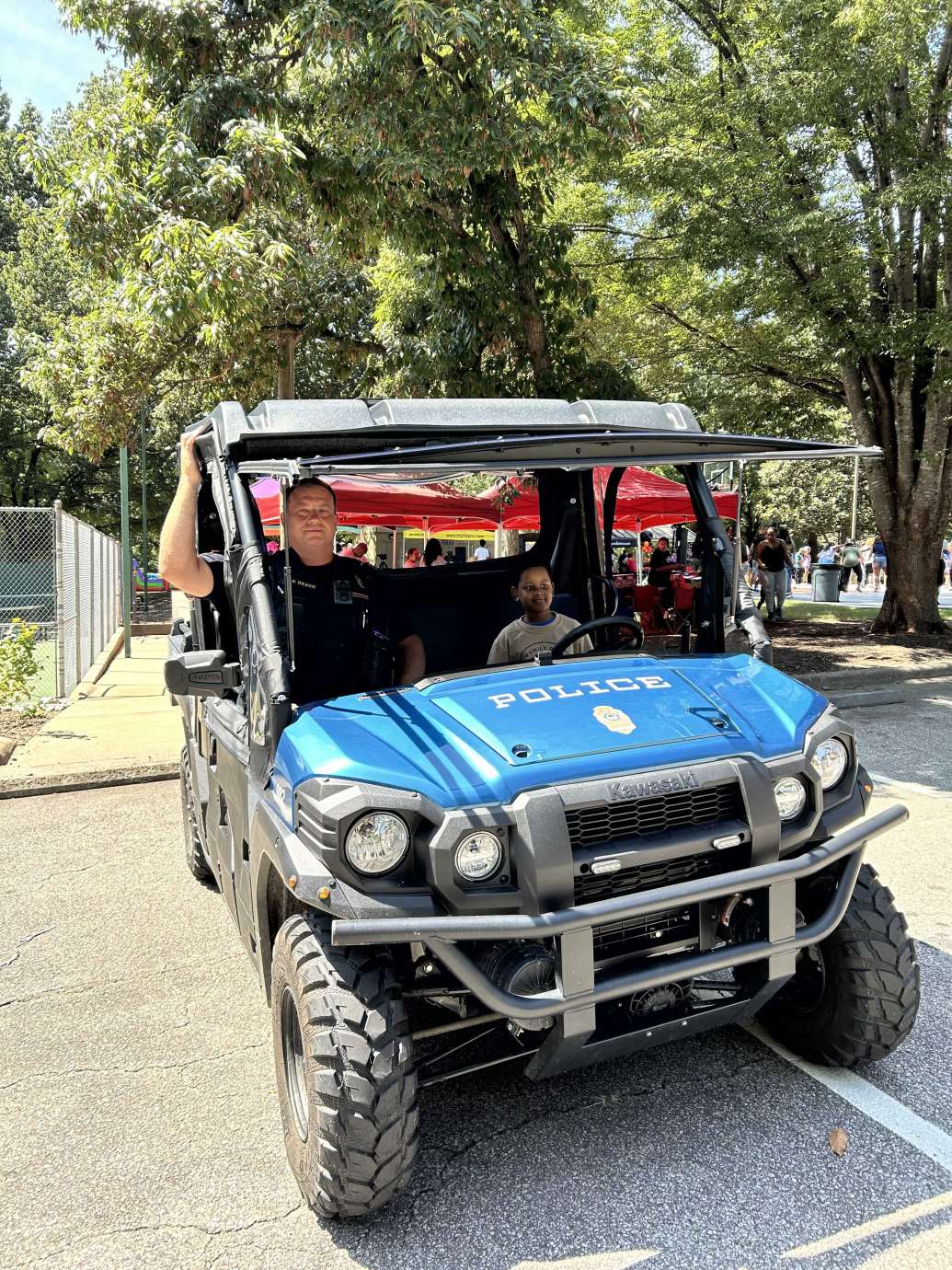 RPD officer and a child sitting in all-terrain vehicle