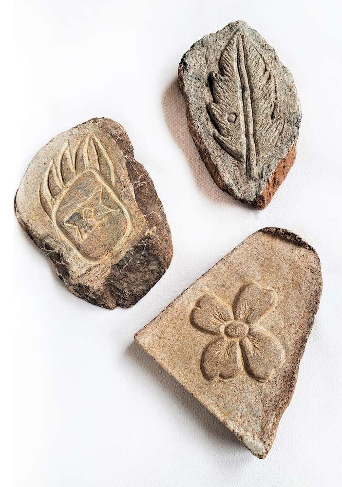 3 stones with etching on them