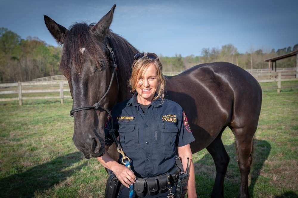 Officer Montemurro stands with unsaddled Willow