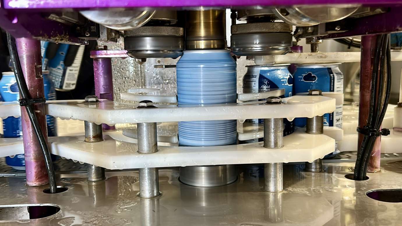 Blue can in canning machine being spun around