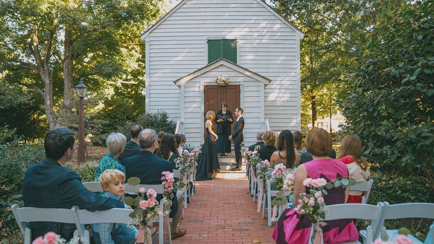 a wedding couple in front of chapel