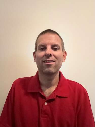 Headshot of Dr. Alan Chase wearing a red collar shirt