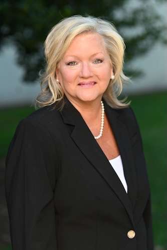 Headshot of Marisa Chrismon wearing a dark suit