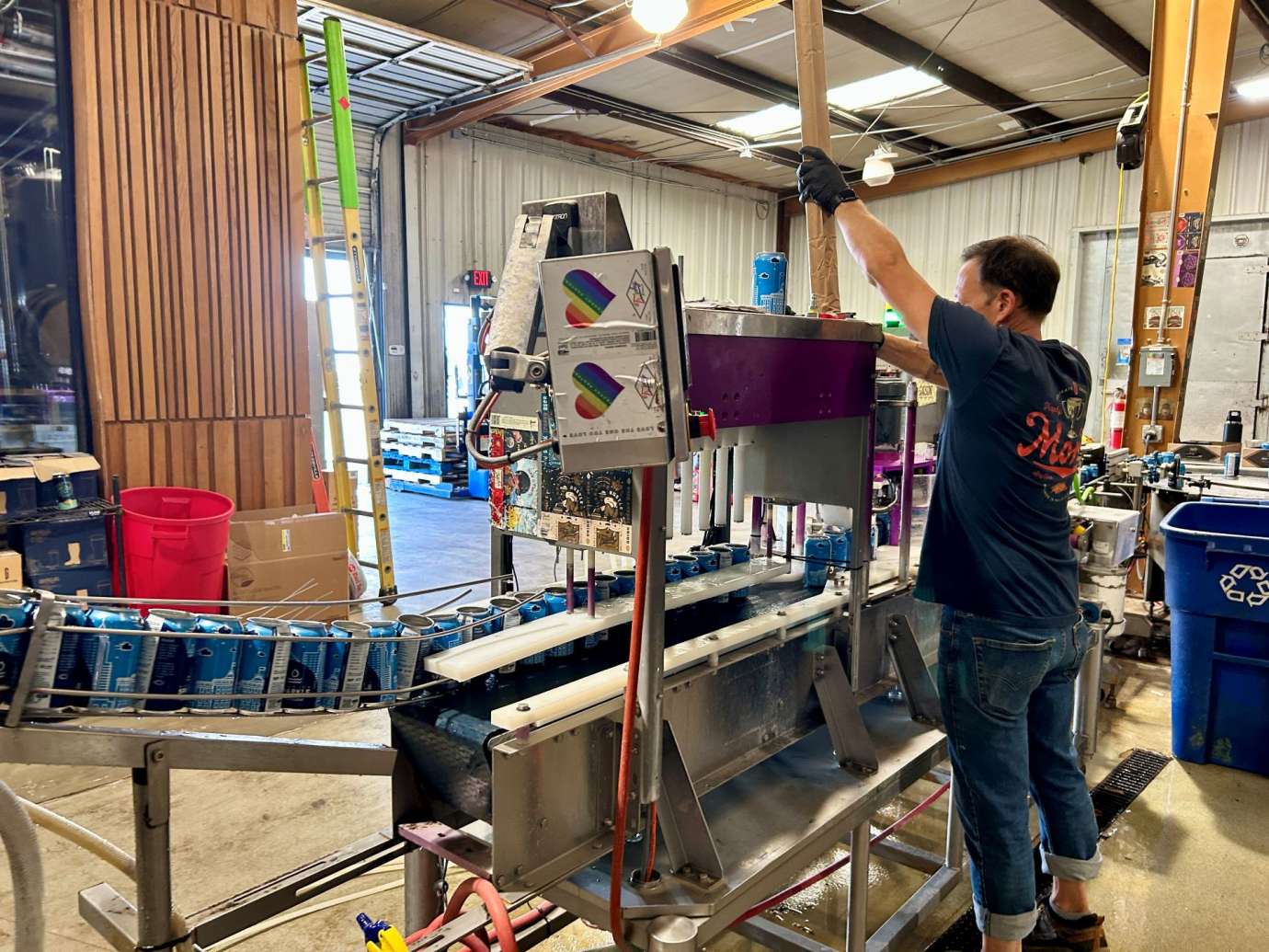 man fixing canning machine 