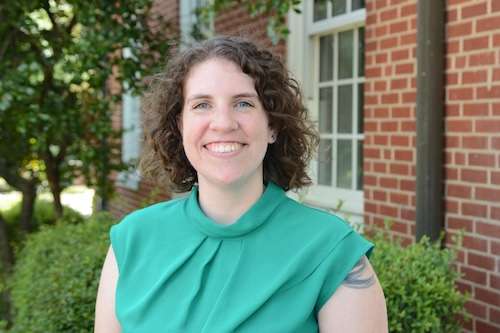 Headshot of Taylor Ofori wearing a green shirt and standing outside