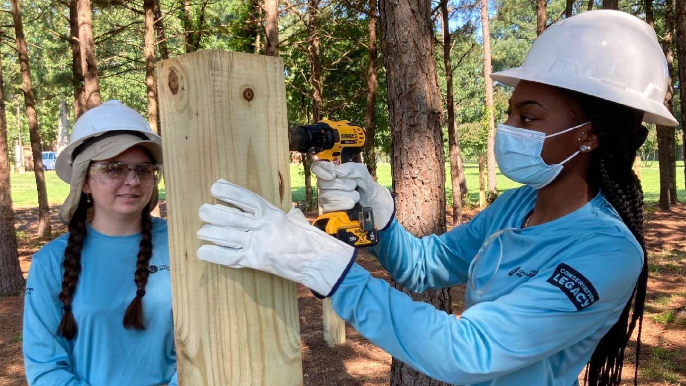 teens building a wood pole