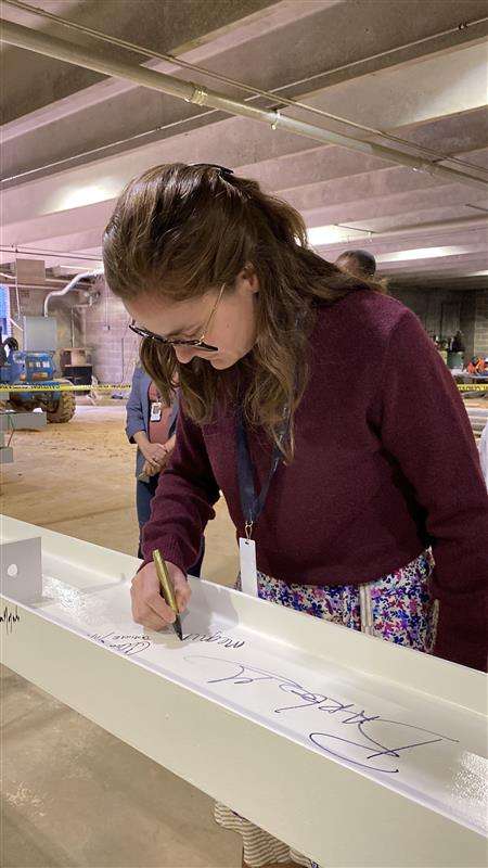 City Council member Megan Patton, signing the top beam of City Hall 
