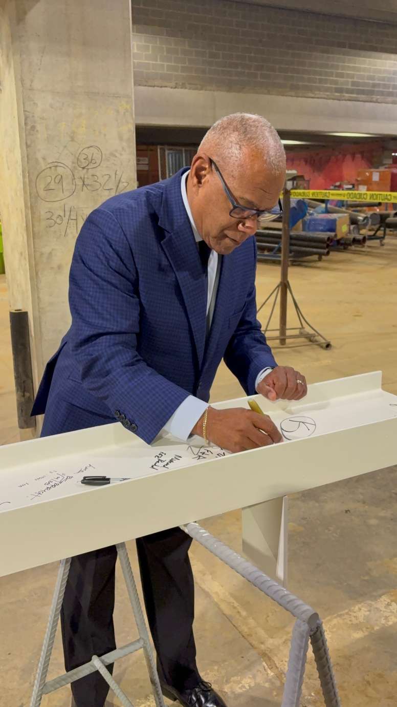 City Council member Mitchell Silver, signing the top beam of City Hall 