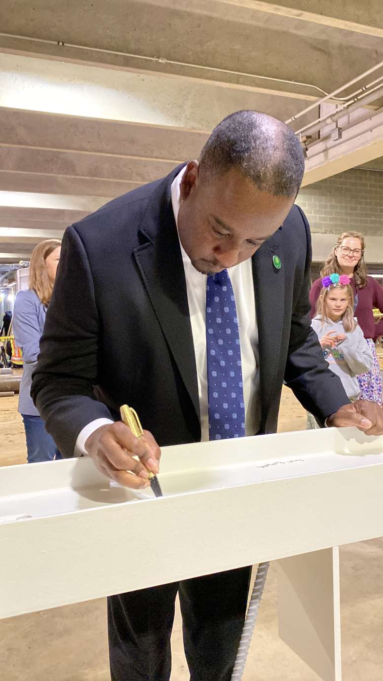 City Council member Corey Branch, signing the top beam of City Hall 