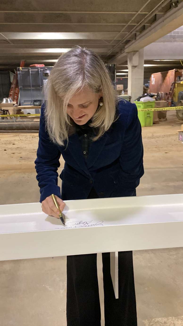 Raleigh City Mayor Janet Cowell, signing the top most beam of the new City Hall.  