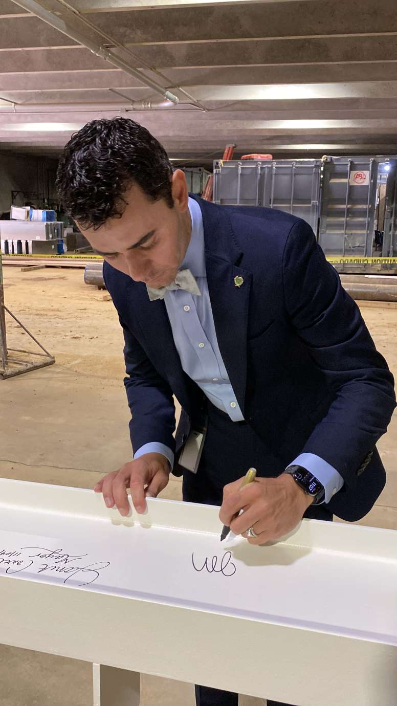 City Council member Jonathan Lambert-Melton, signing the top beam of City Hall 