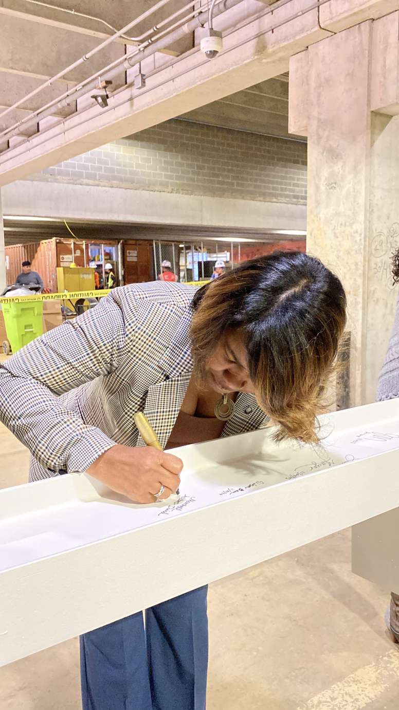 Raleigh City Manager Marchell Adams-David, signing the top beam of City Hall 