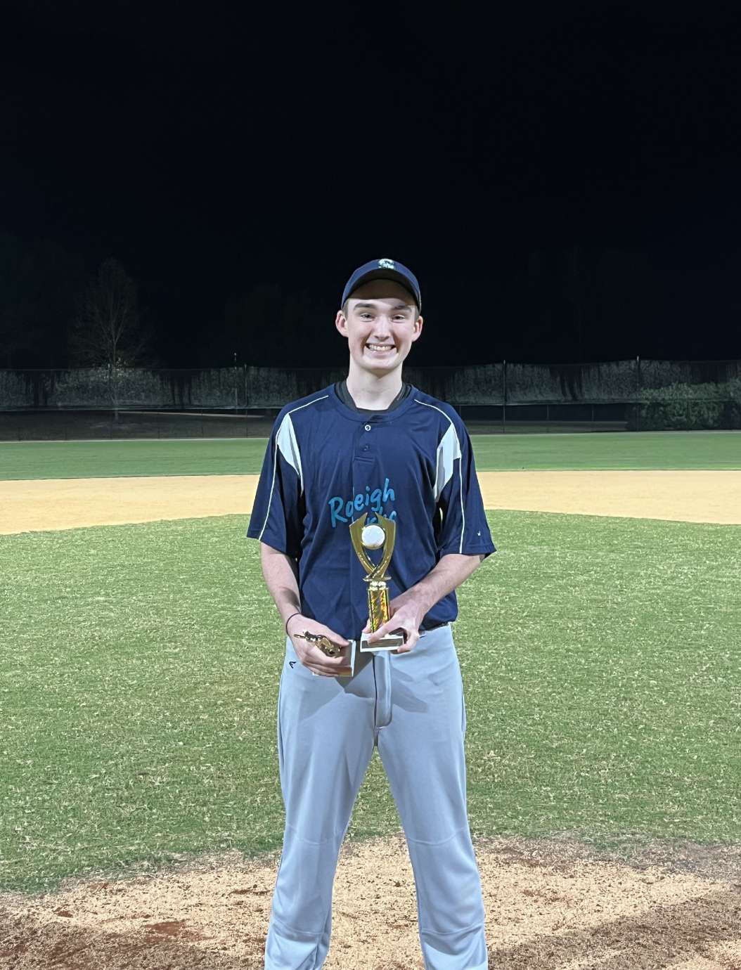 a boy holding a trophy