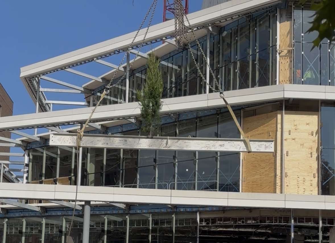 Top most beam of city hall being lifted to top of building 