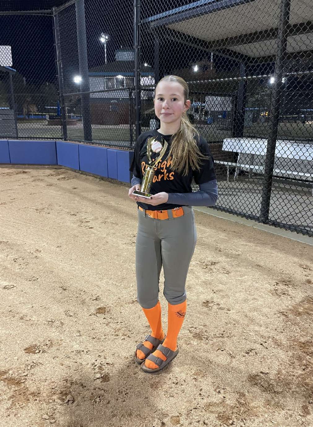a girl holding an award