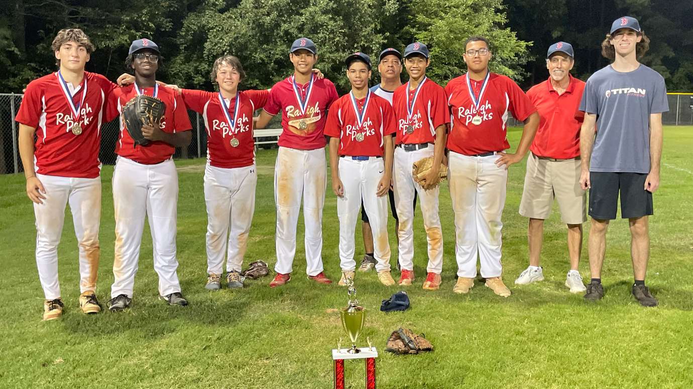 a group of kids in baseball uniforms with trophy