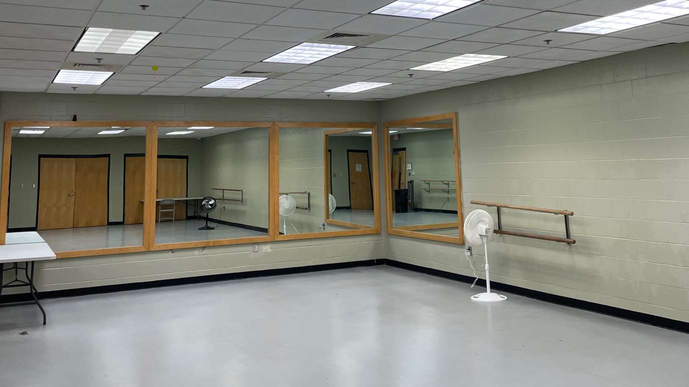 A dance studio with bars and mirrors 