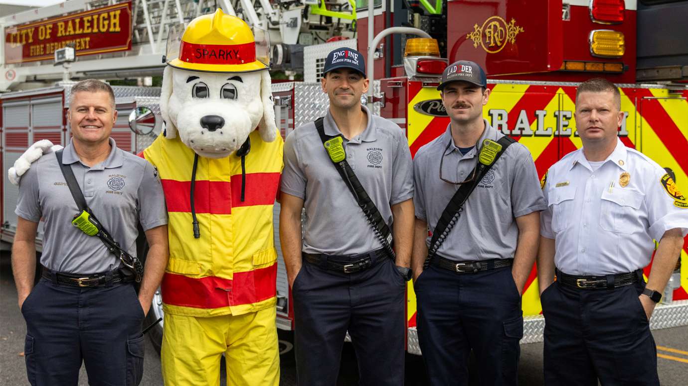 Raleigh Firefighters standing with Sparky