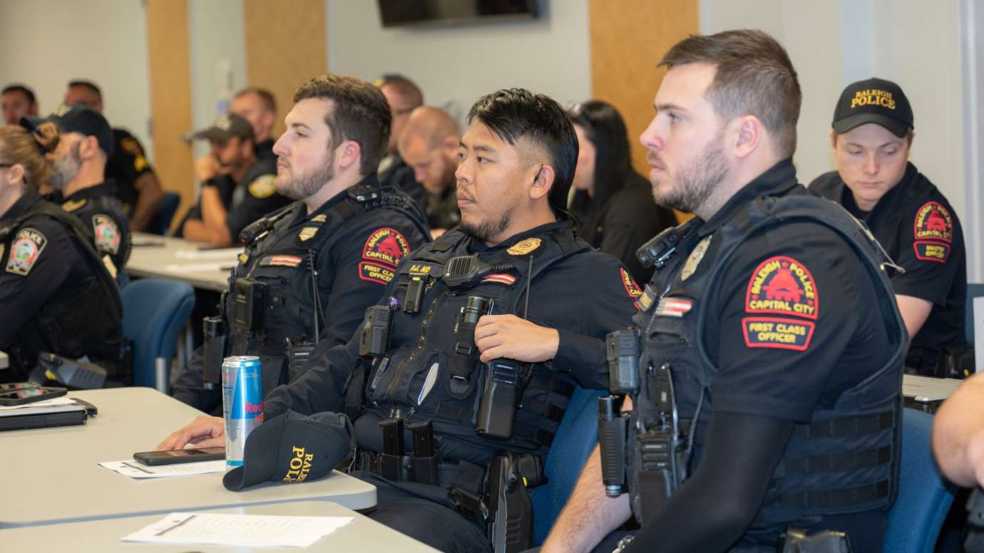 RPD officers sitting in conference room meeting
