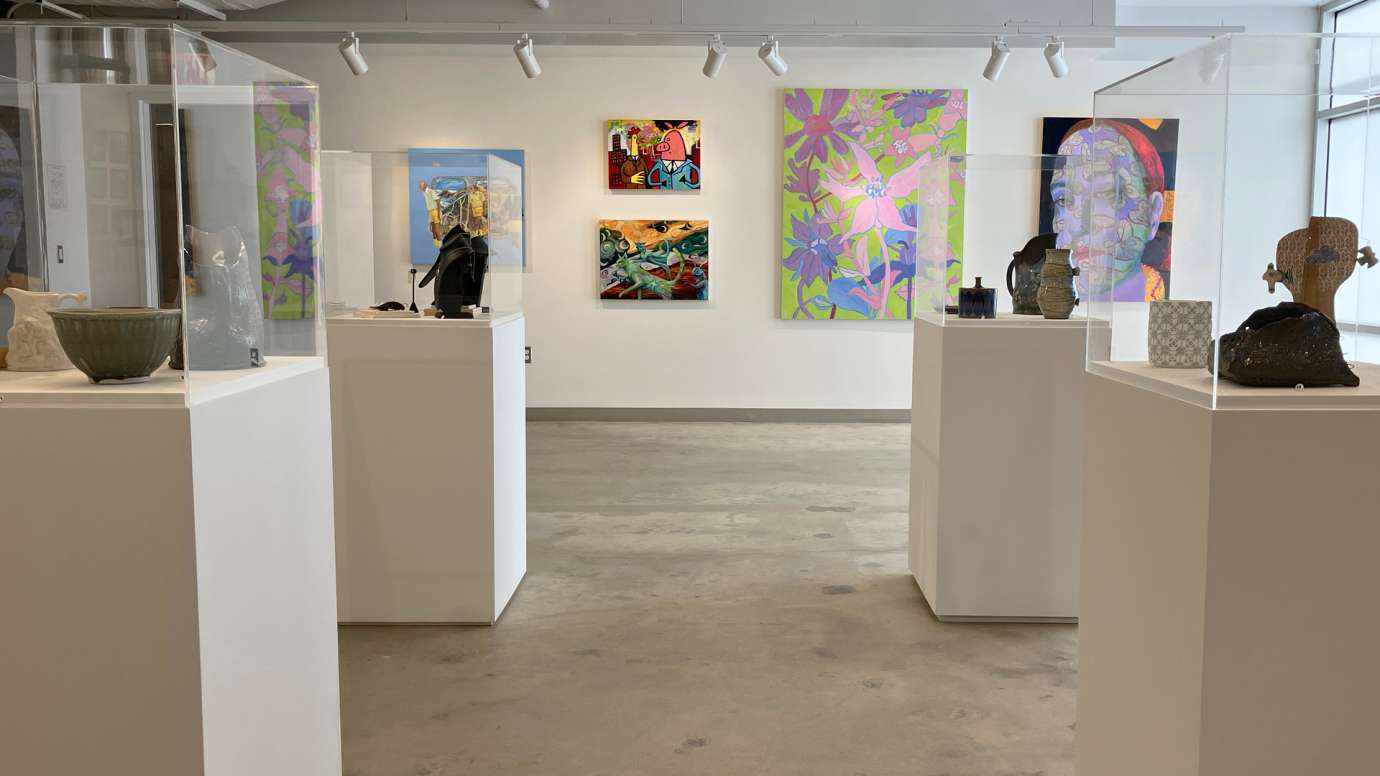Installation view of the gallery with four pedestals with 3D works and several paintings installed along the back wall
