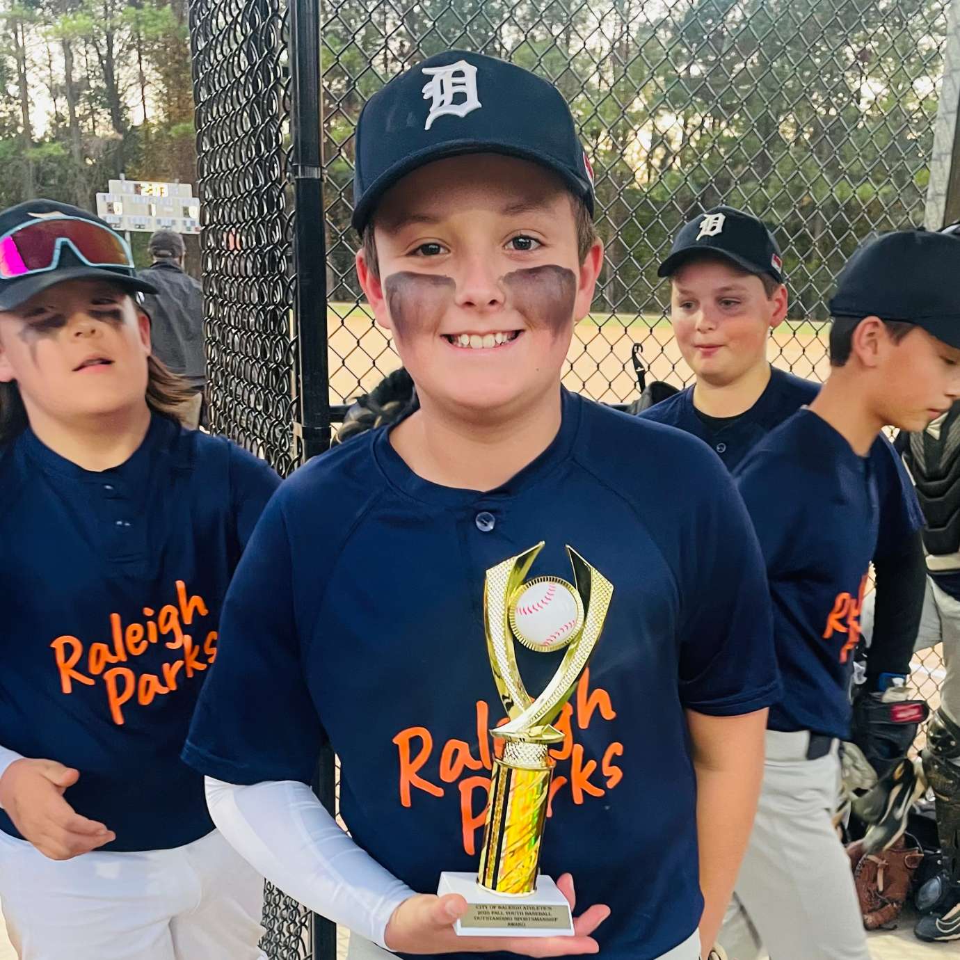 baseball player holding a trophy