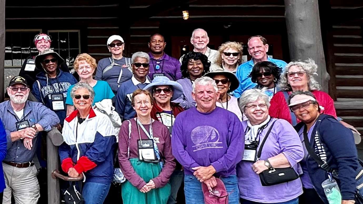 a group of adults on a trip smiling