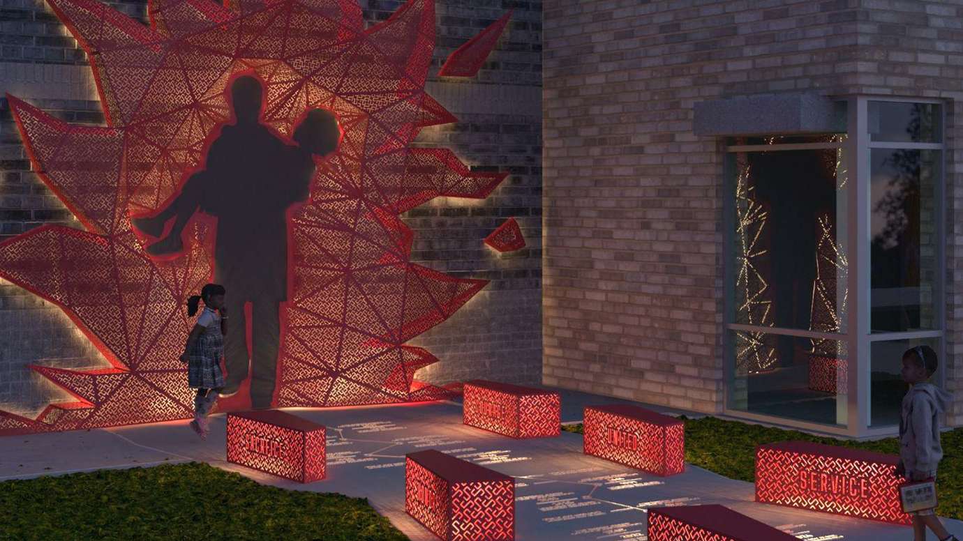 A red sculpture of a firefighter with flames and six red benches glow at night