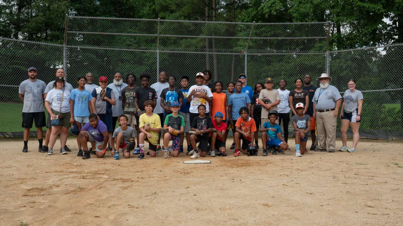 Baseball team standing behind home plate
