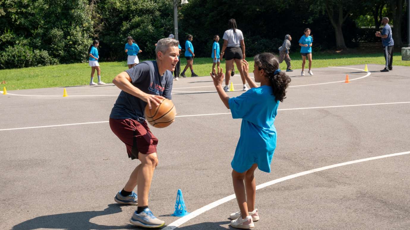 Youth basketball coach dribbling ball