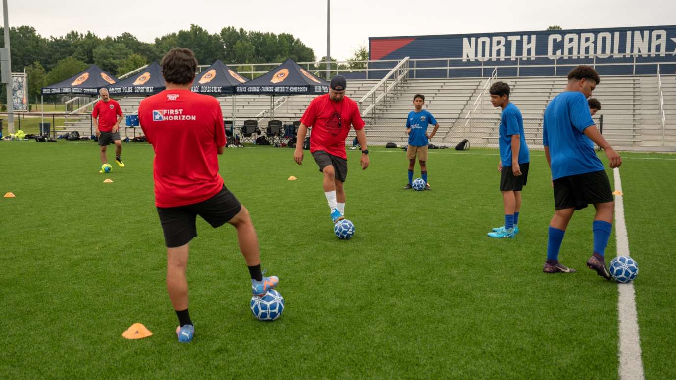 Youth soccer team dribbling soccer balls