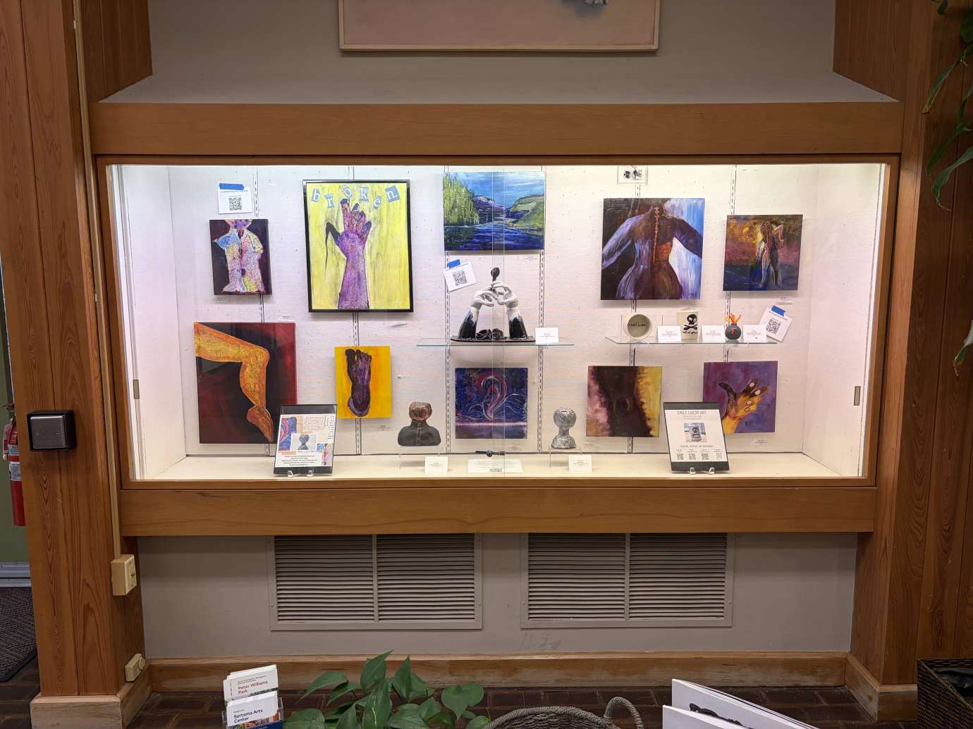 Paintings and ceramics by Emily Ligon in the Wall Case