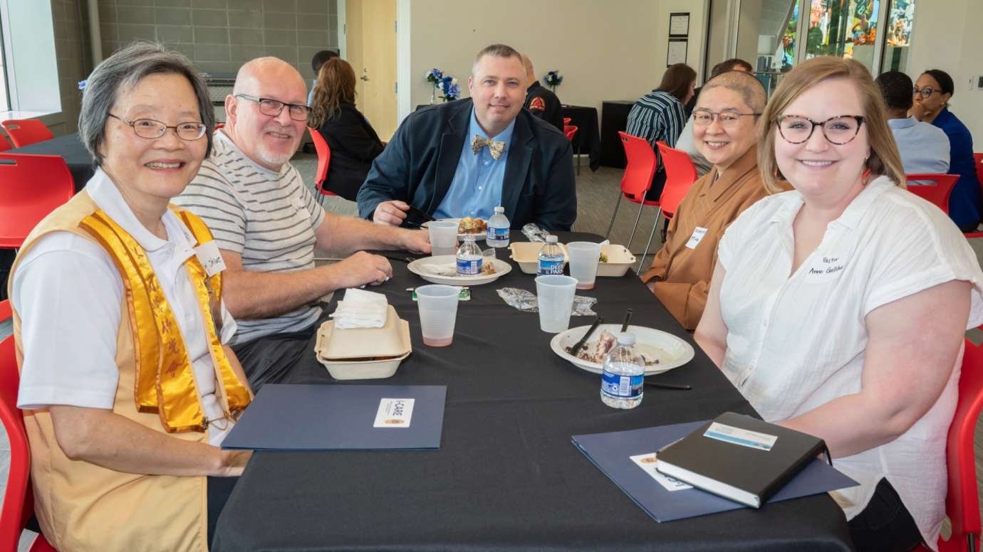 Five people sitting at lunch table