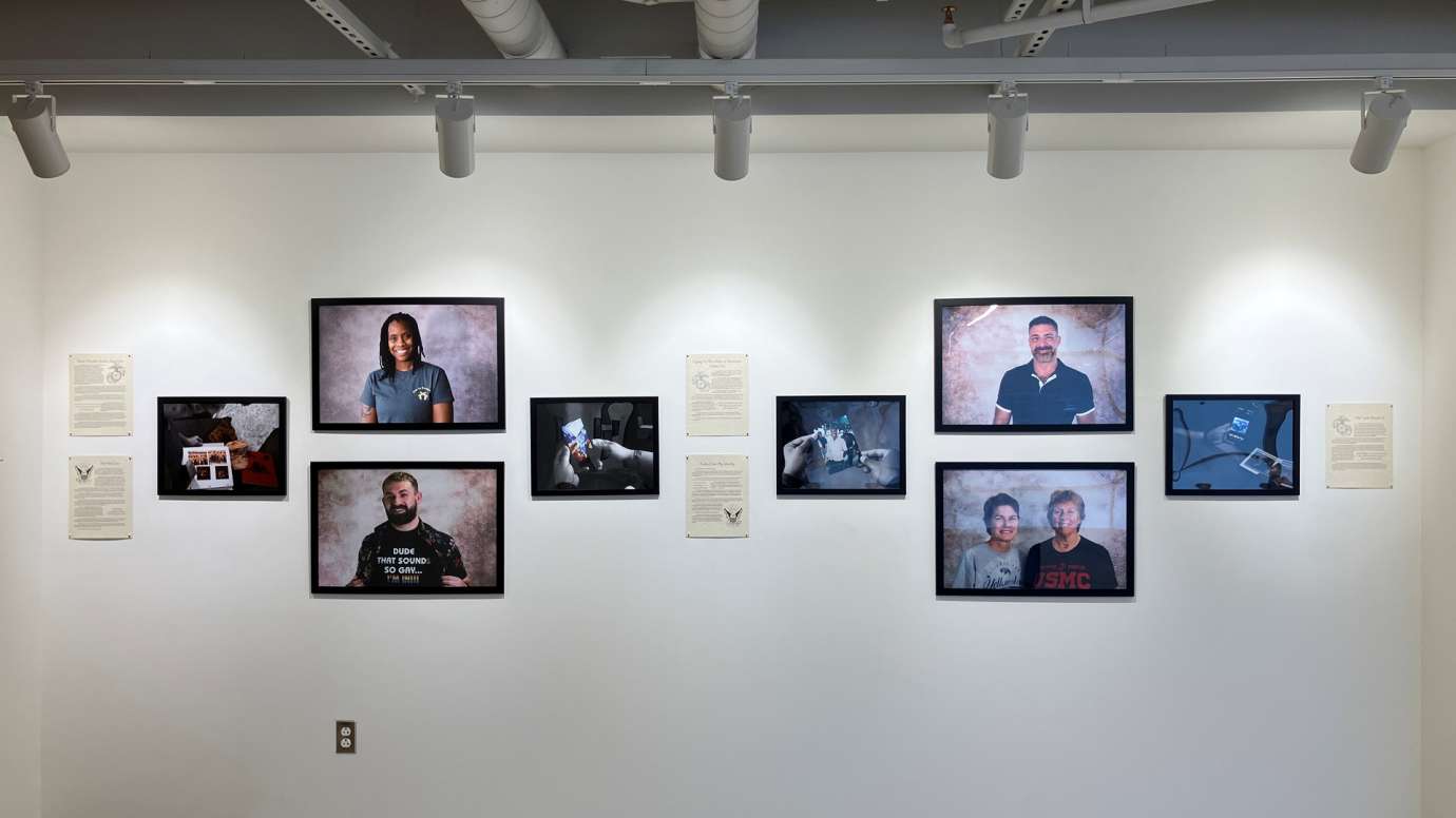 Installation of Don't Ask Don't Tell exhibit featuring portrait photos and written statements at Pullen Arts Center