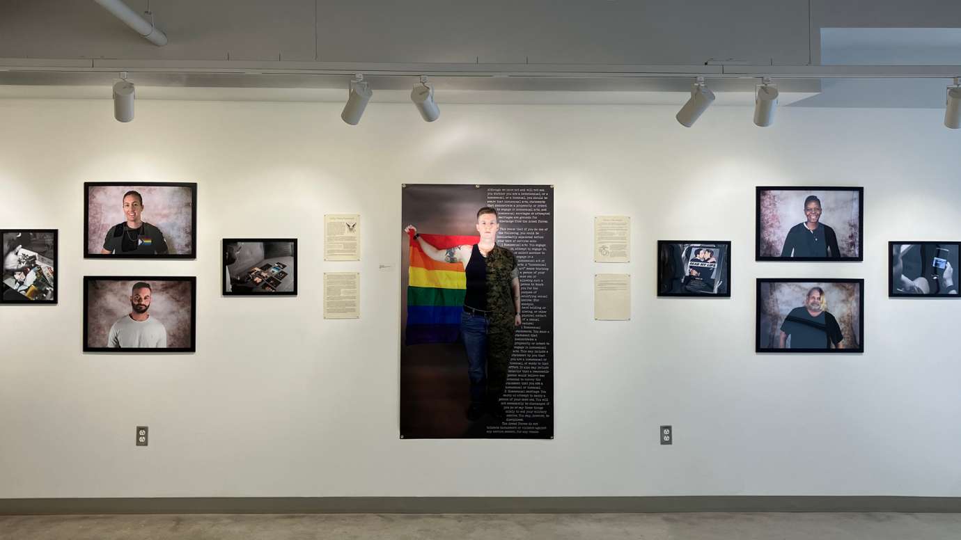 Installation of Don't Ask Don't Tell exhibit featuring portrait photos and written statements at Pullen Arts Center