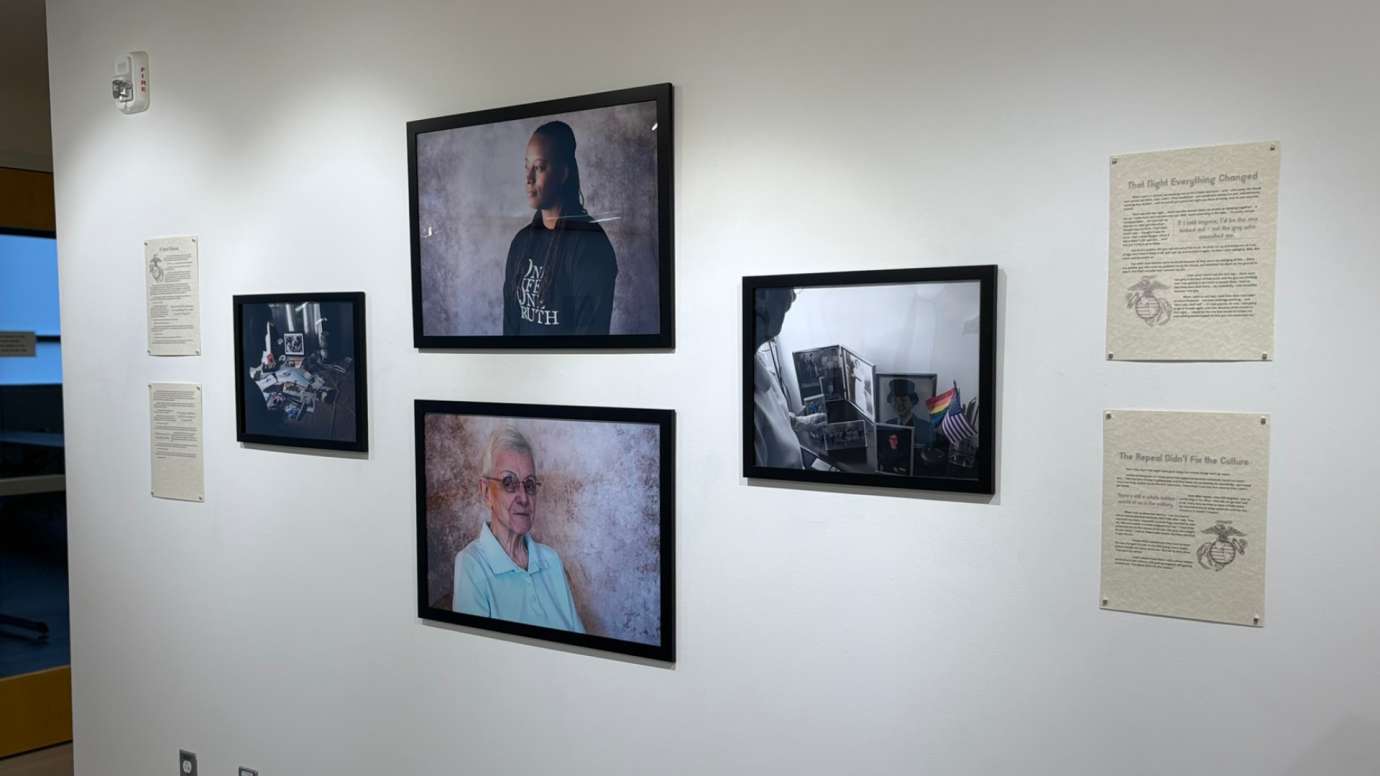 Installation of Don't Ask Don't Tell exhibit featuring portrait photos and written statements at Pullen Arts Center