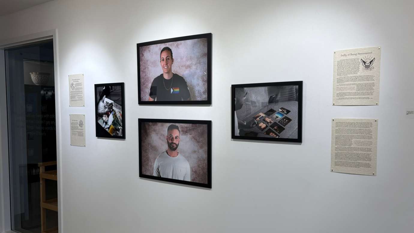 Installation of Don't Ask Don't Tell exhibit featuring portrait photos and written statements at Pullen Arts Center