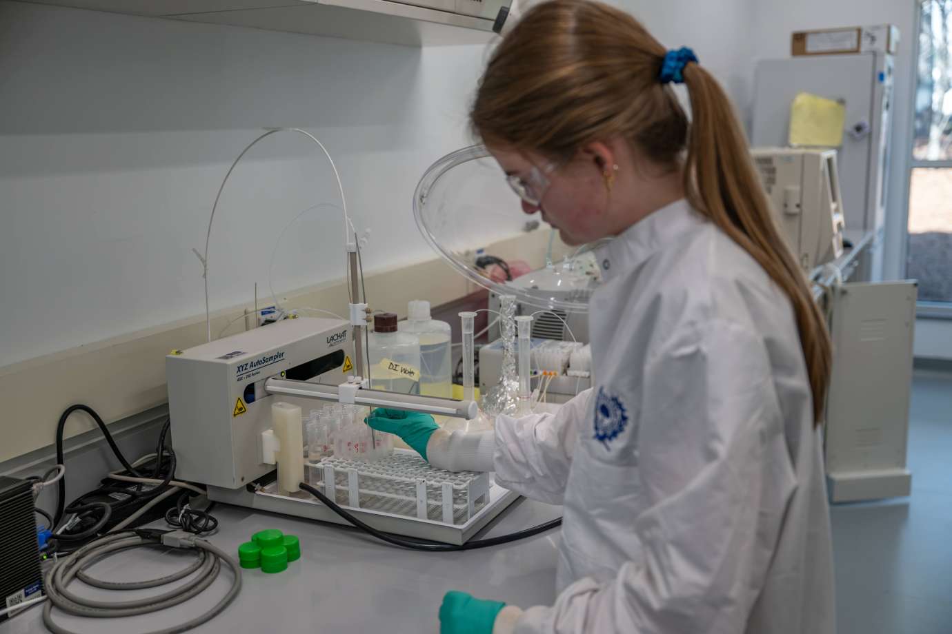 Worker testing samples in a water lab