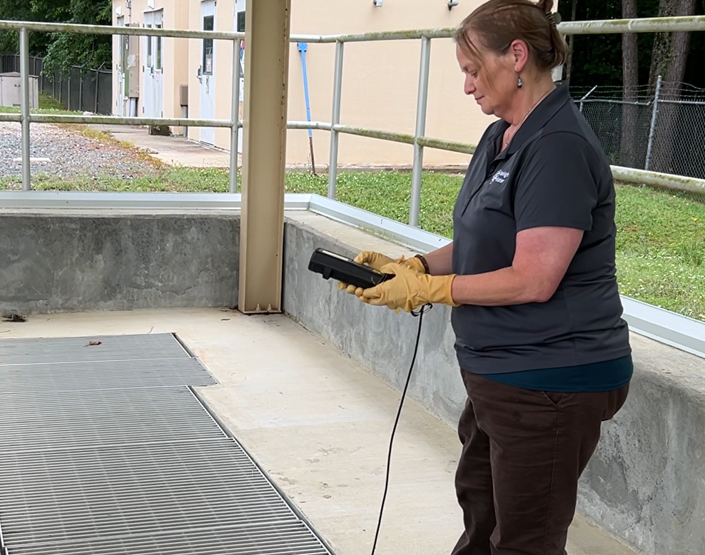 Water worker checking information at the Smith Creek wastewater plant