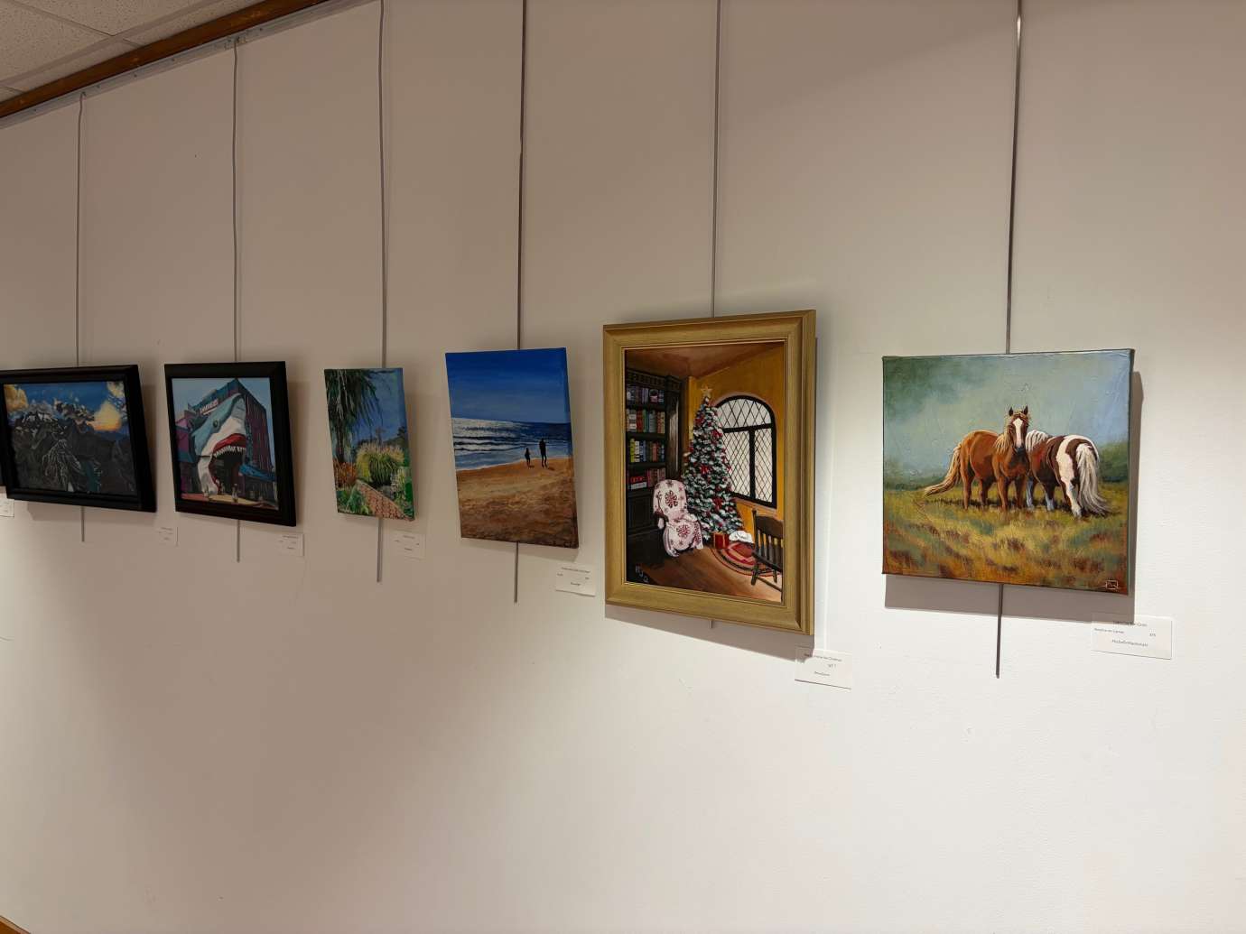 paintings in a variety of mediums on display 