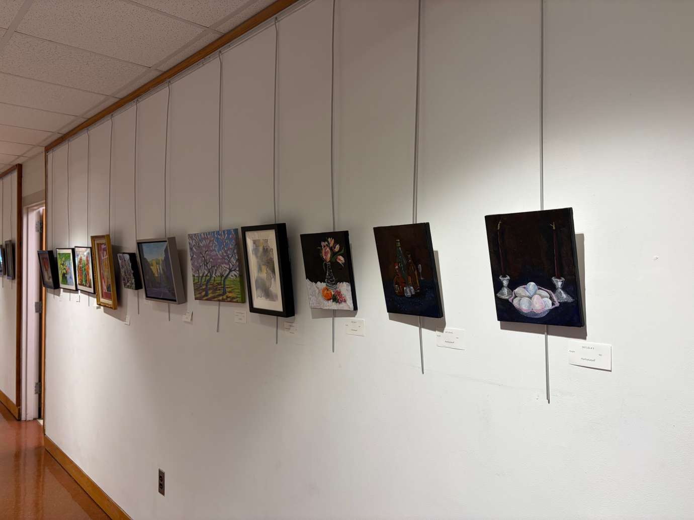 paintings in a variety of mediums on display 