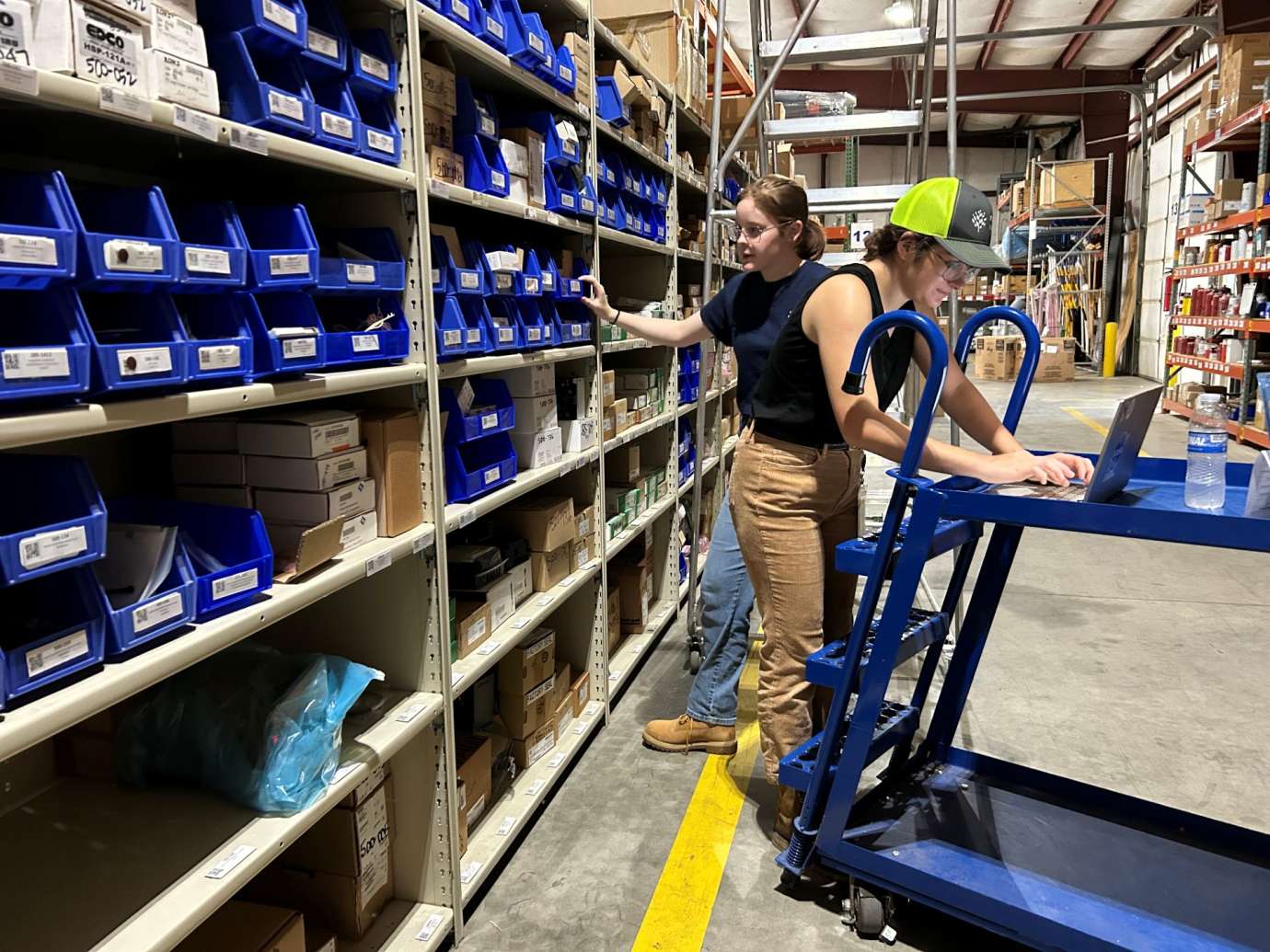 Workers in a water warehouse logging information
