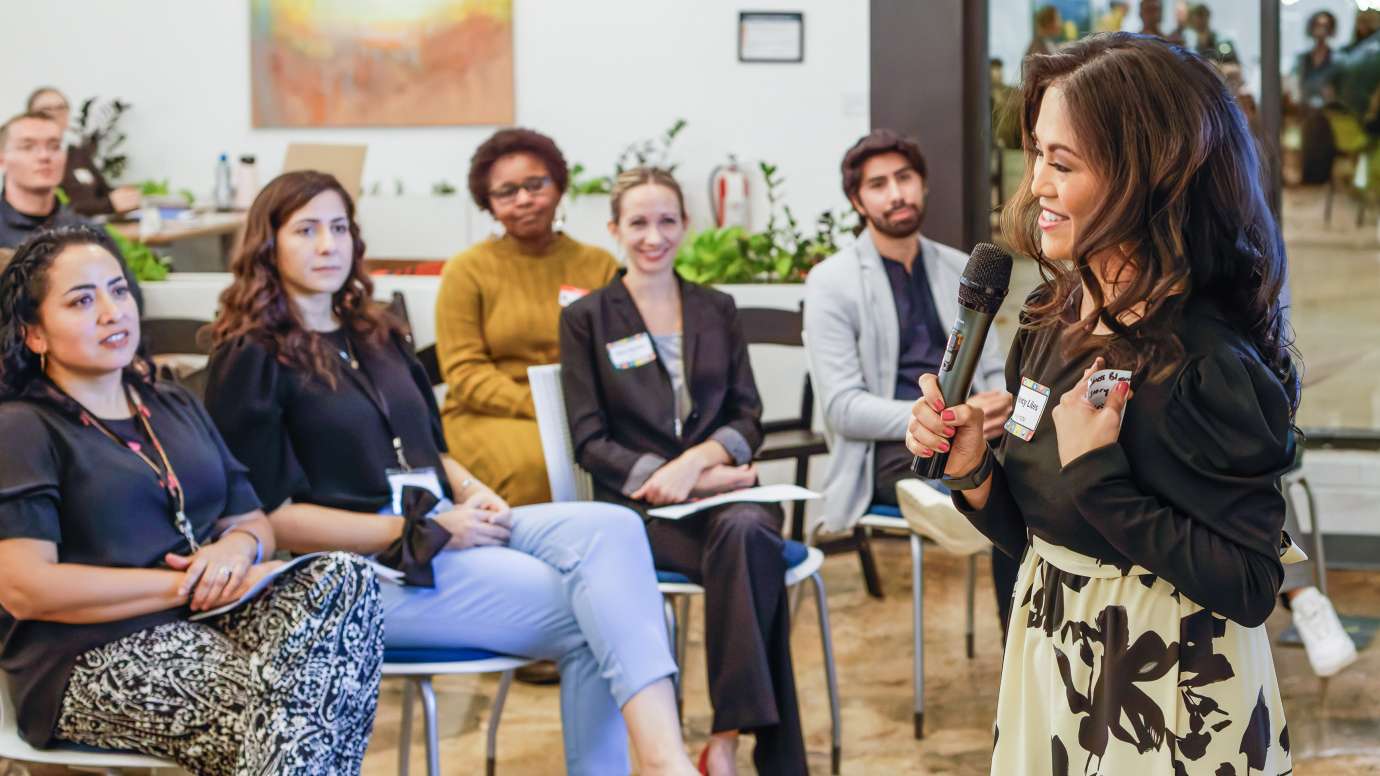a small group of people listening to a presenter 