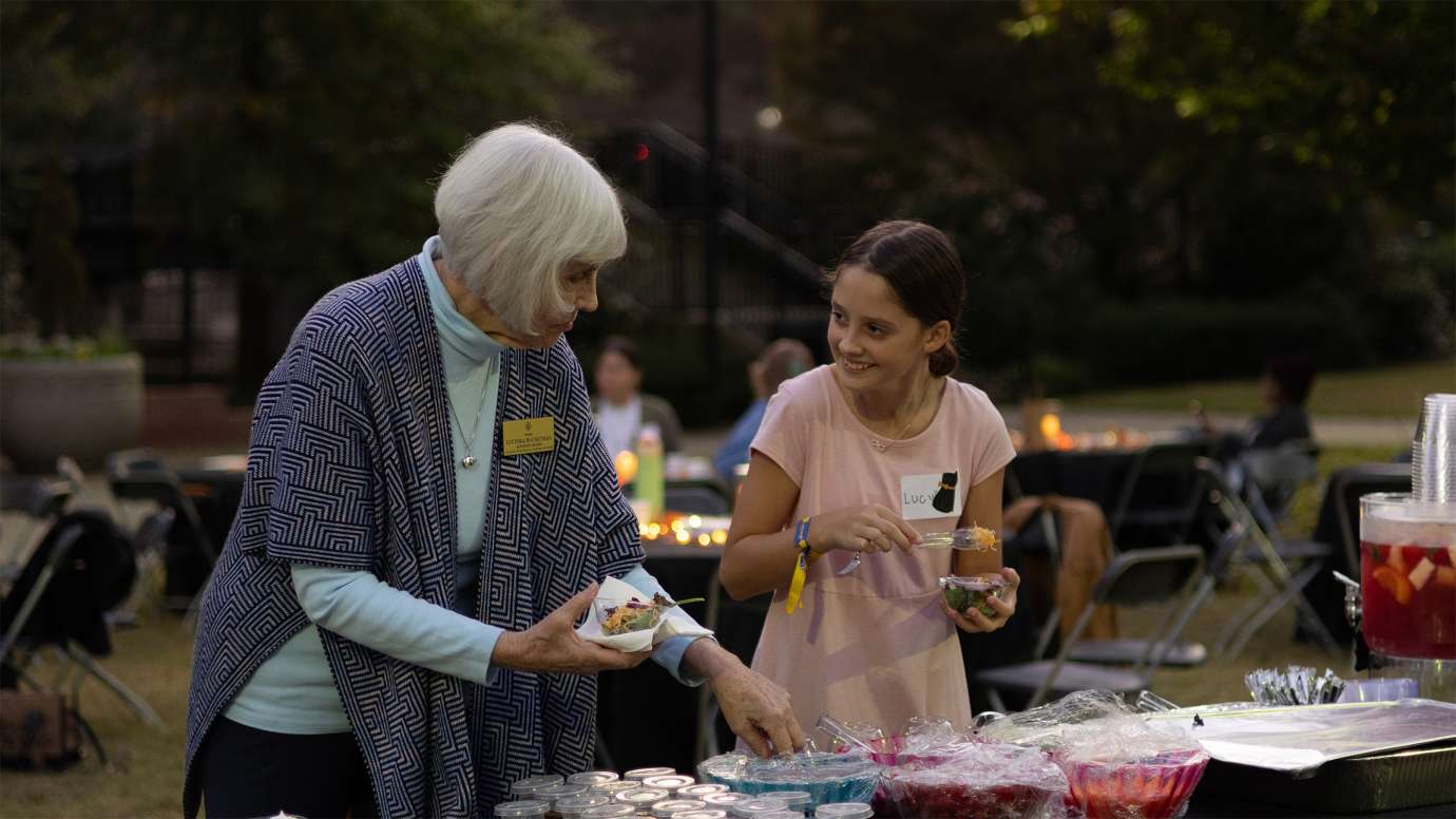 two people making snack plates while smiling