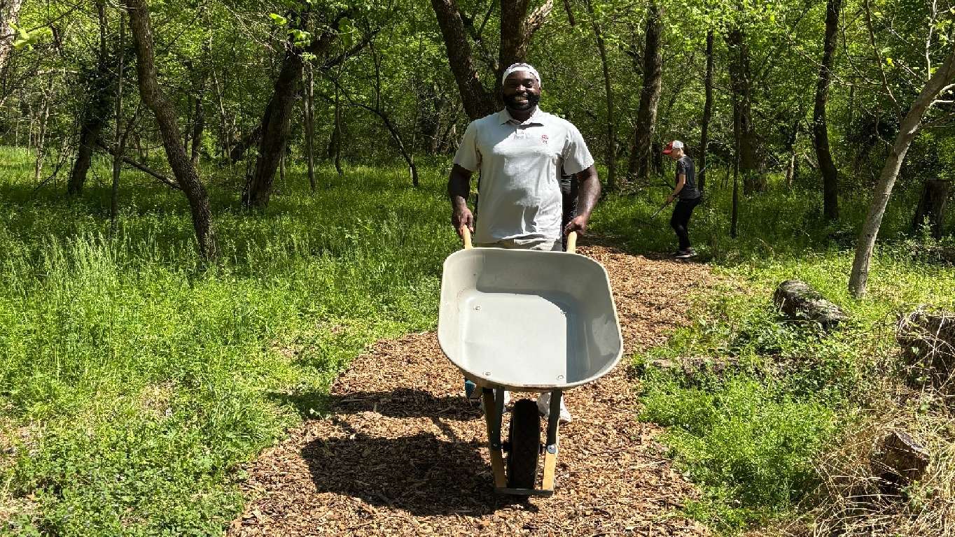 a man moving a wheelbarrel