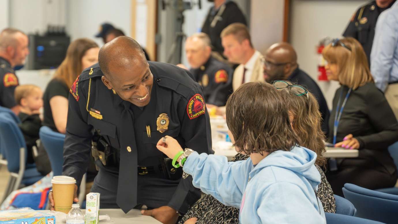 Police officer greeting child