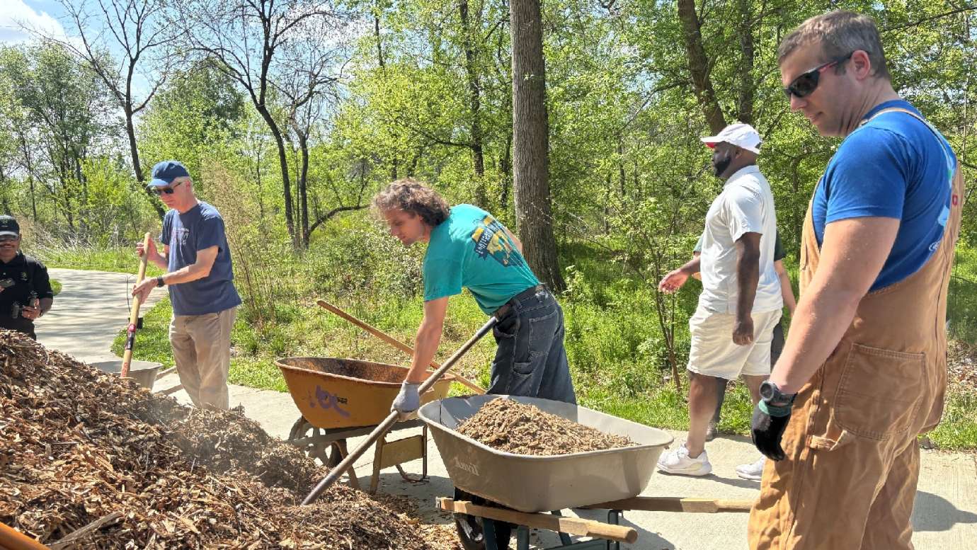 volunteering shoveling dirt