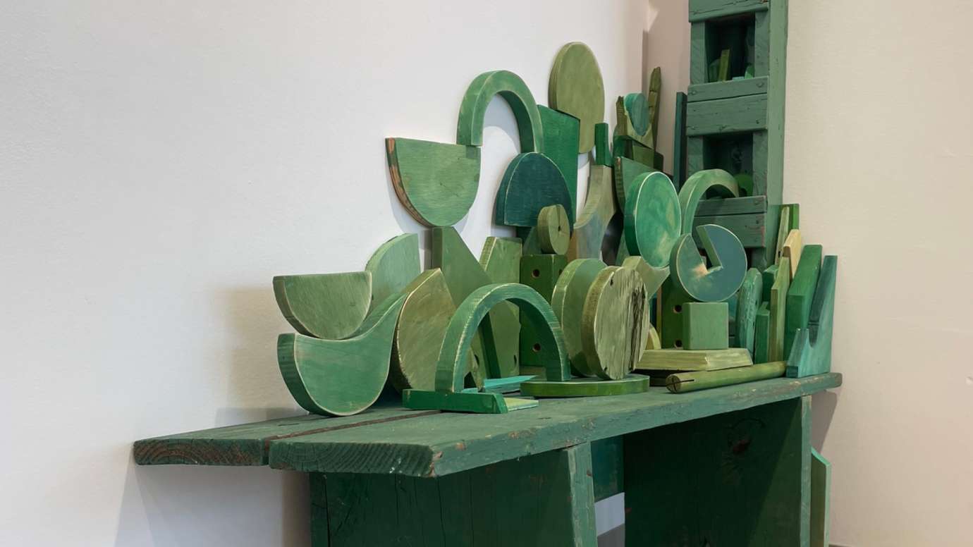 Detail of mixed media wooden sculpture in shades of green by Jason Lord