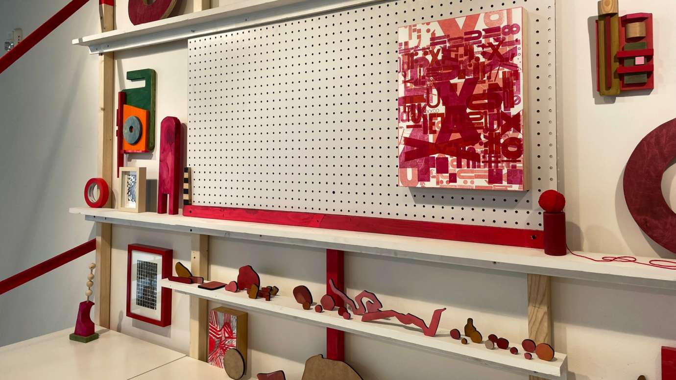 Detail of mixed media installation by Jason Lord composed of peg board, wood and paintings
