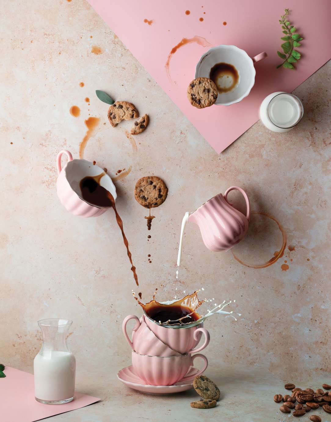 Coffee and milk pouring into pink mug