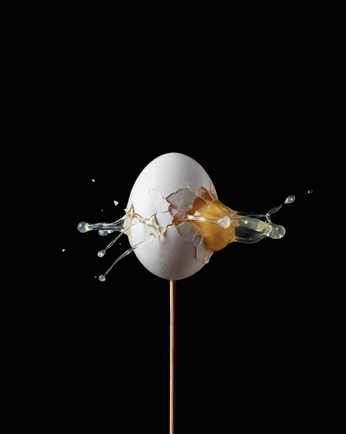 Egg yolk bursting out of shell
